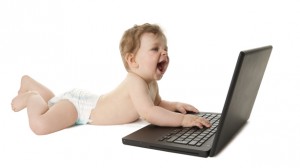 baby playing with laptop