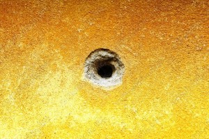 bullet hole in wall