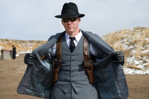 well dressed man with dual shoulder holsters carrying 1911 handguns