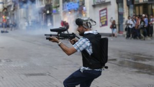 police officer in instanbul fires pepper paintballs to dispurse crowd