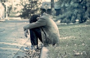 sad guy sitting on curb